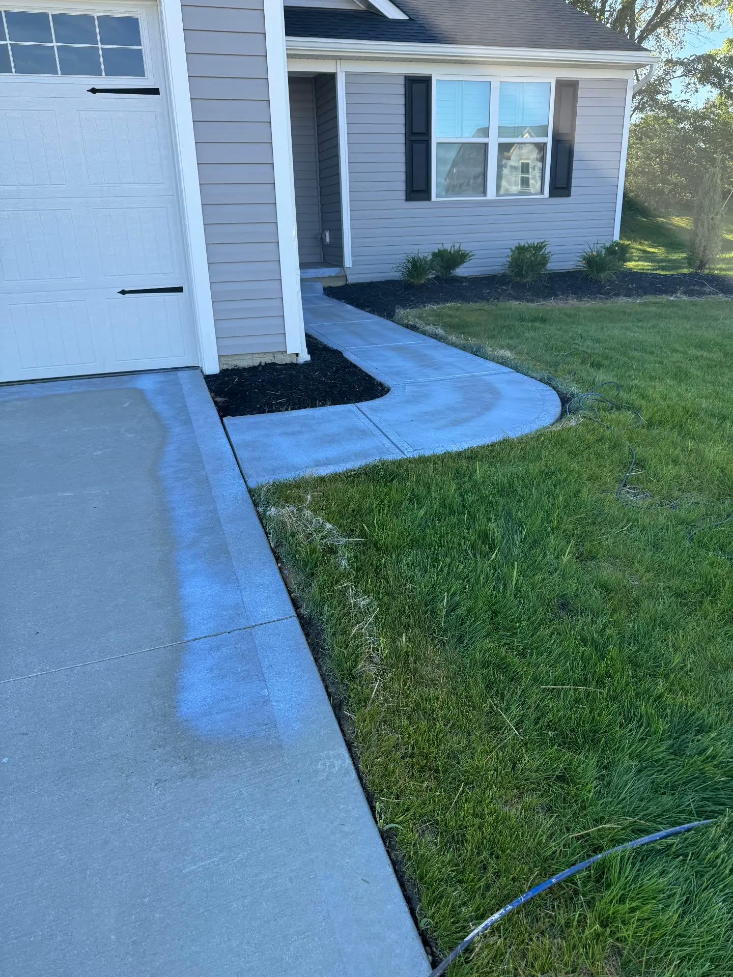 Hand-scrubbing black streaks off white gutters in Canton, Ohio