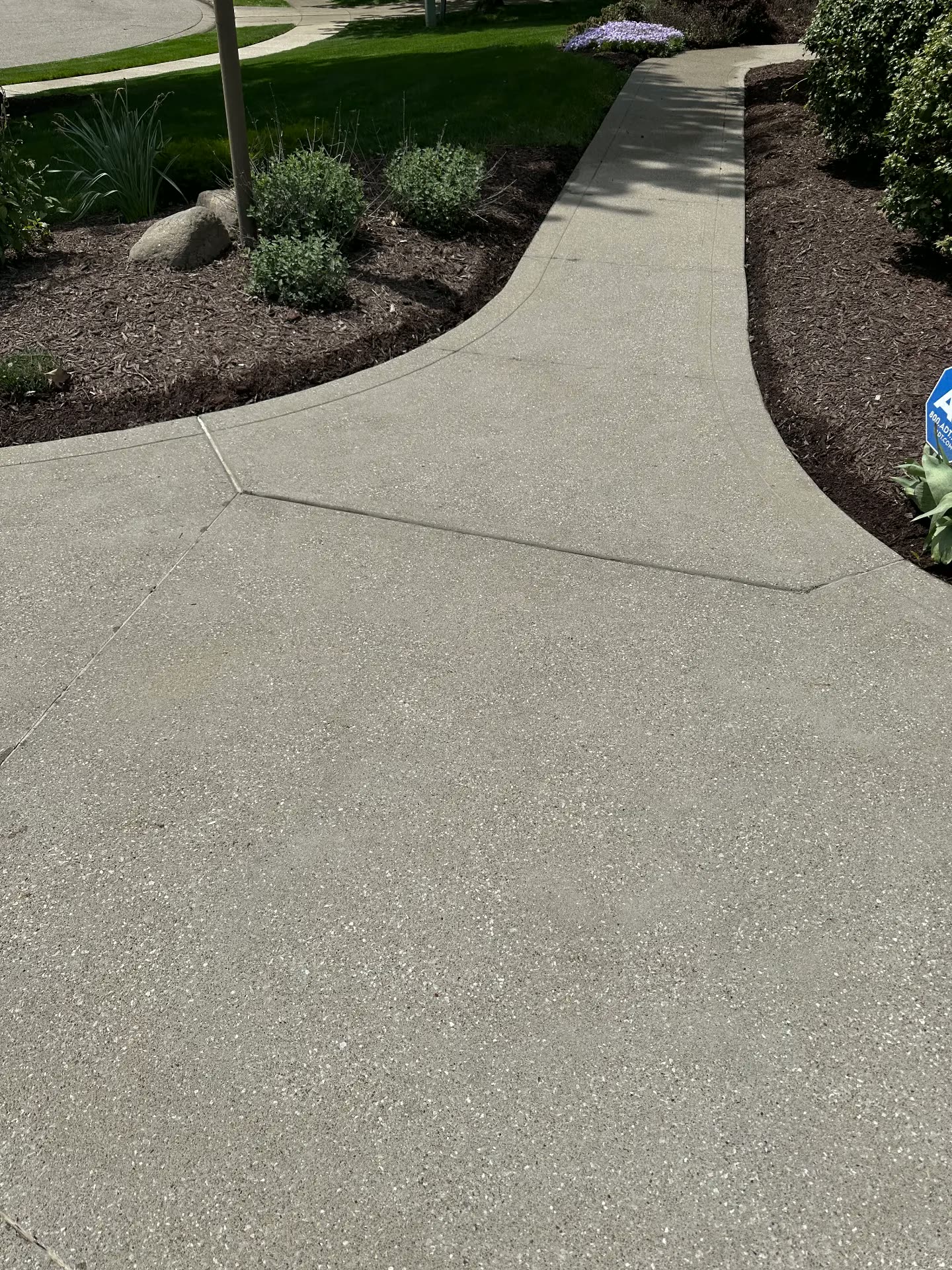 Bright clean concrete walkway after cleaning