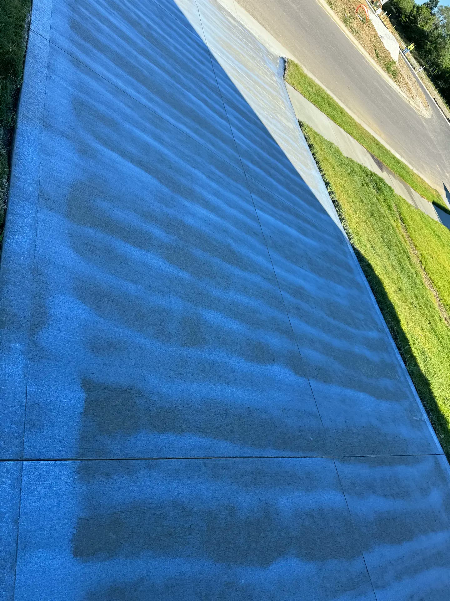 Concrete driveway being washed with a surface cleaner